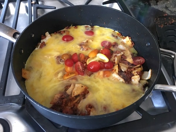 Adding egg and tortillas to the frying pan.