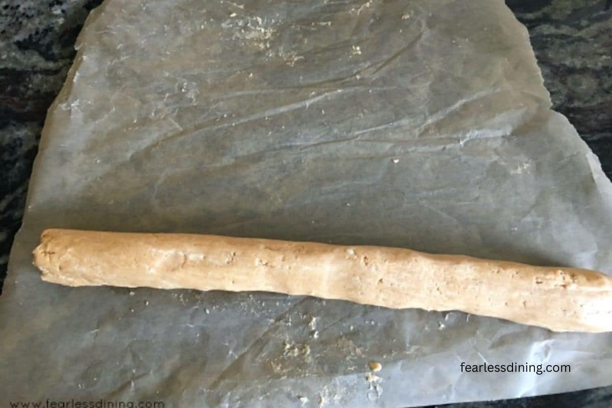 A roll of peanut butter candy, ready to be sliced.