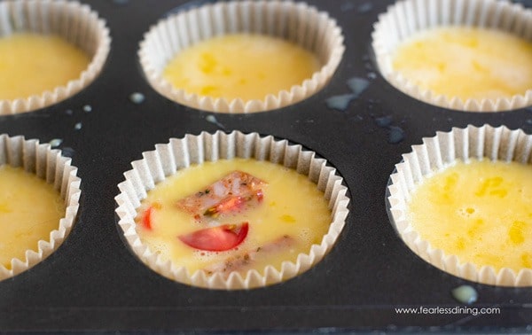 Egg muffins in a muffin tin ready to bake.