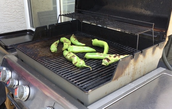 hatch chiles blistering on a gas grill