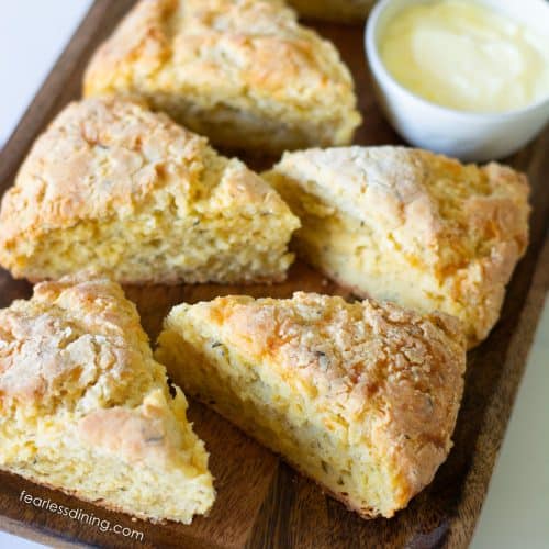 Wedge shaped gluten-free cheese scones on a wooden platter.