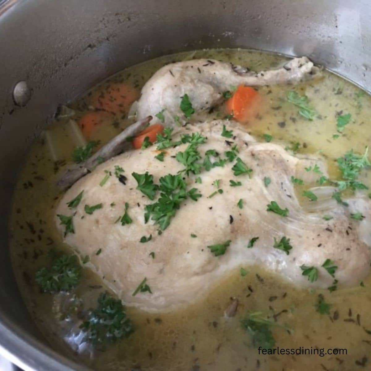 A pot of cooked chicken soup.