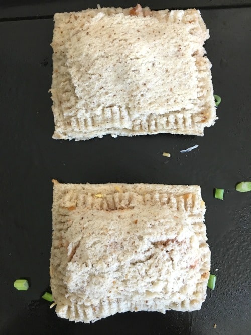 Sandwiches on a baking sheet.