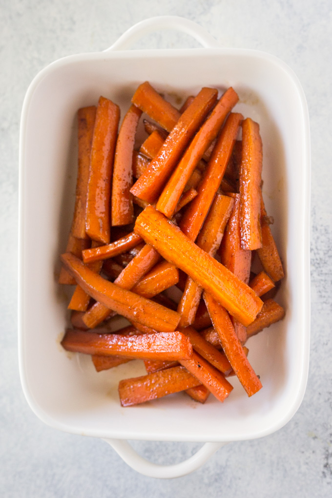 Brown sugar carrots in a rectangular white casserole dish.