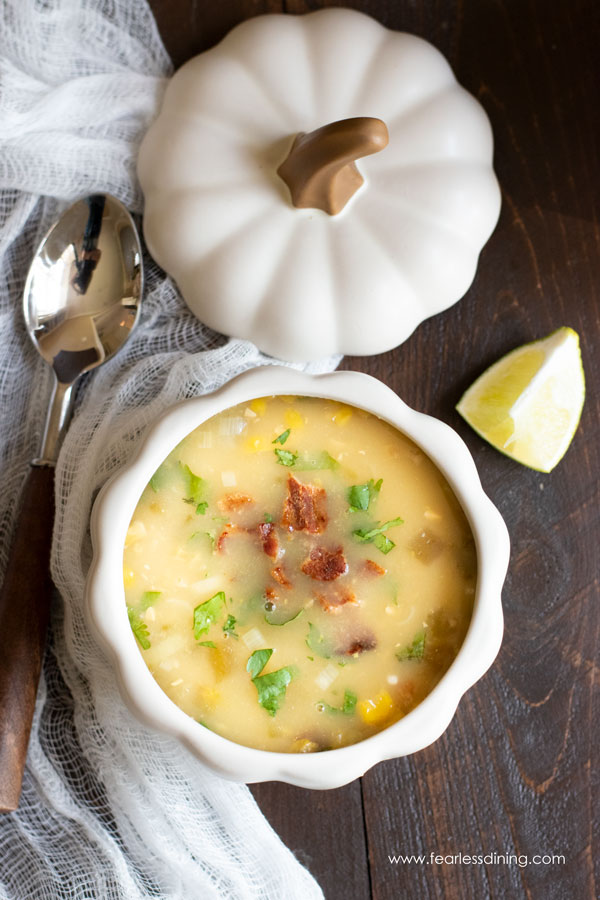 The top view creamy corn chowder in a white pumpkin bowl.