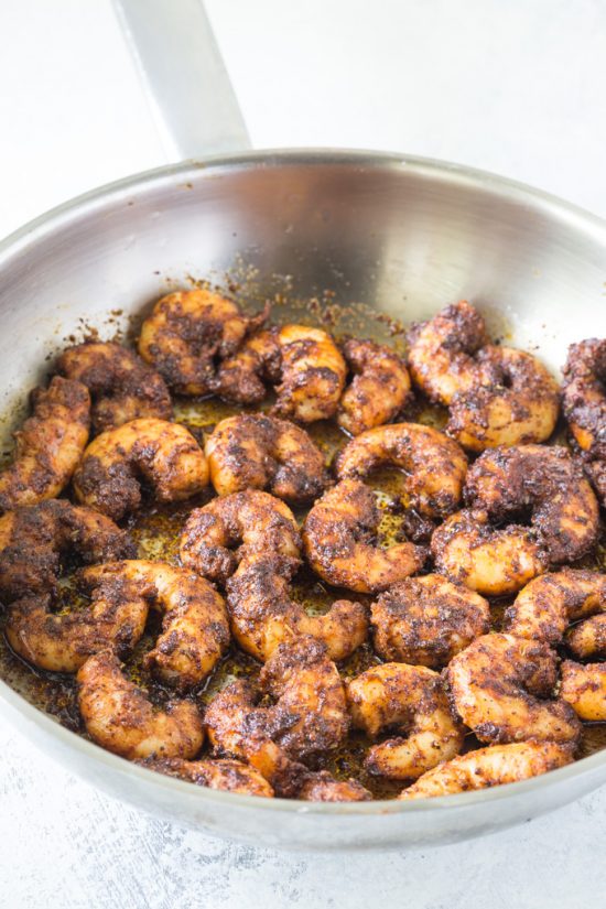 Cooking the blackened shrimp in a pan.