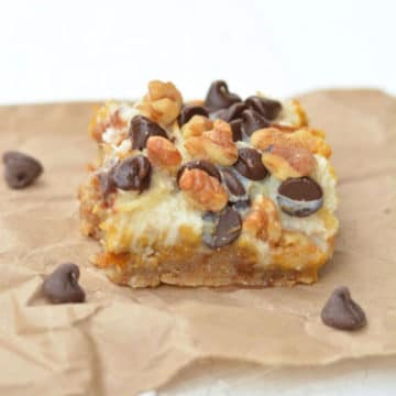 A pumpkin 7 layer bar on a piece of brown paper bag.