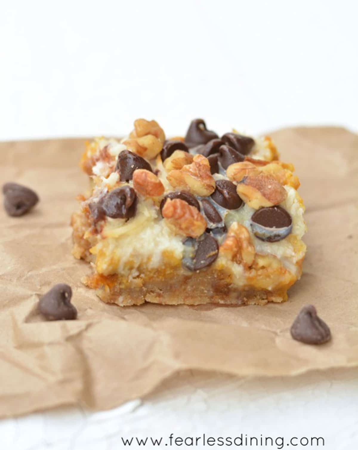 A pumpkin 7 layer bar on a piece of brown paper bag.