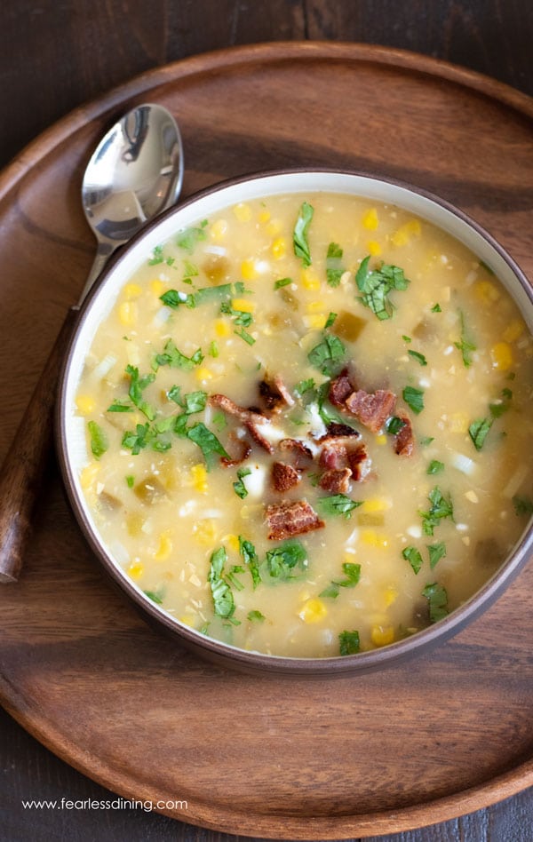 top view of a bowl of corn chowder topped with bacon and cilantro