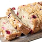 A sliced loaf of gluten free banana cranberry bread.