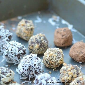 Rows of coated truffles in a pan.