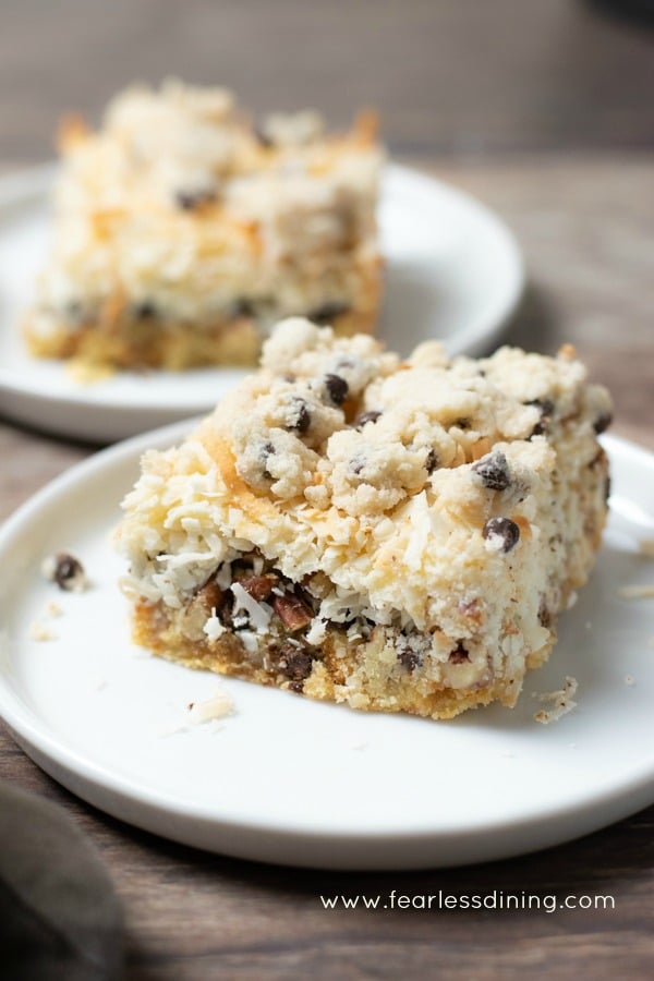two cookie dough bars on white plates.