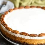 A whole gluten free pumpkin cheesecake on a table.