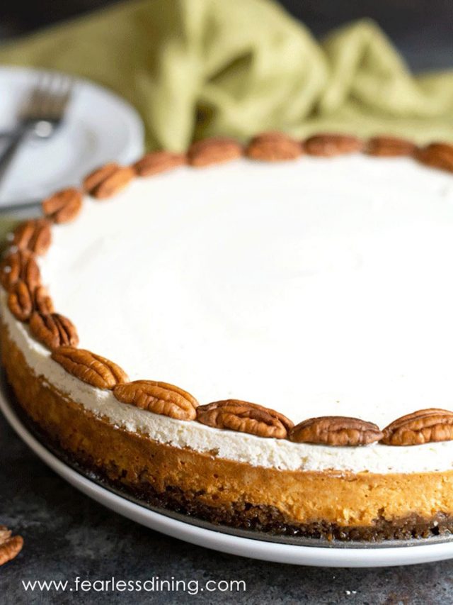 A whole gluten free pumpkin cheesecake on a table.