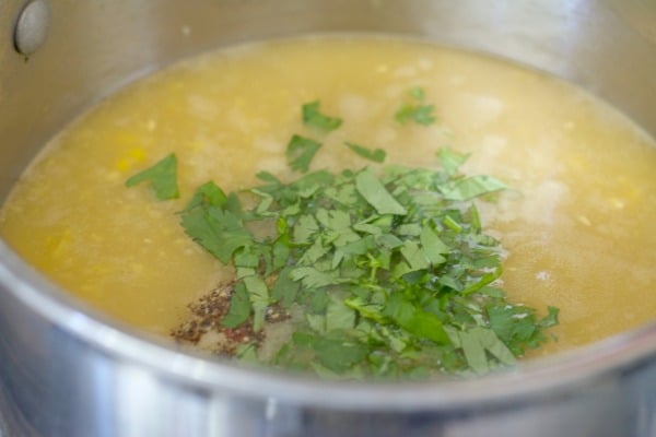 The corn chowder ingredients in a soup pot.