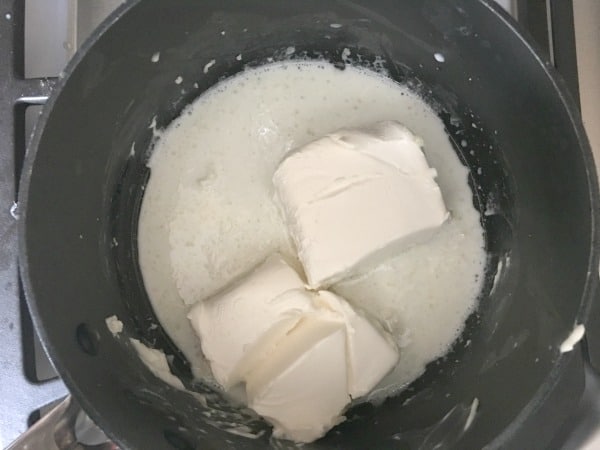 Cooking the cream cheese sauce in a pot.
