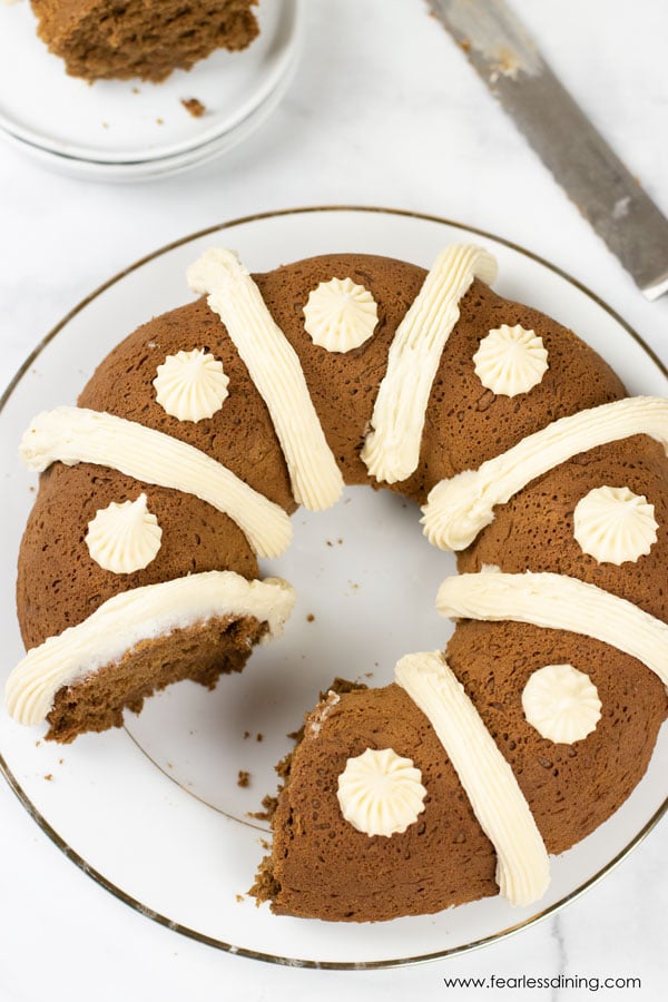 The top view of a gluten free gingerbread bundt cake with a slice cut out.