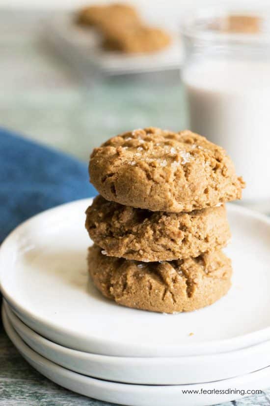 A stack of three gluten free molasses cookies on a plate.