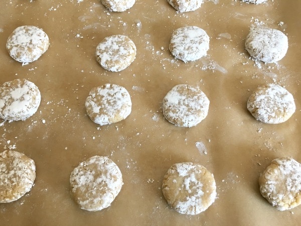 Smooshed cookie dough balls on a baking sheet.