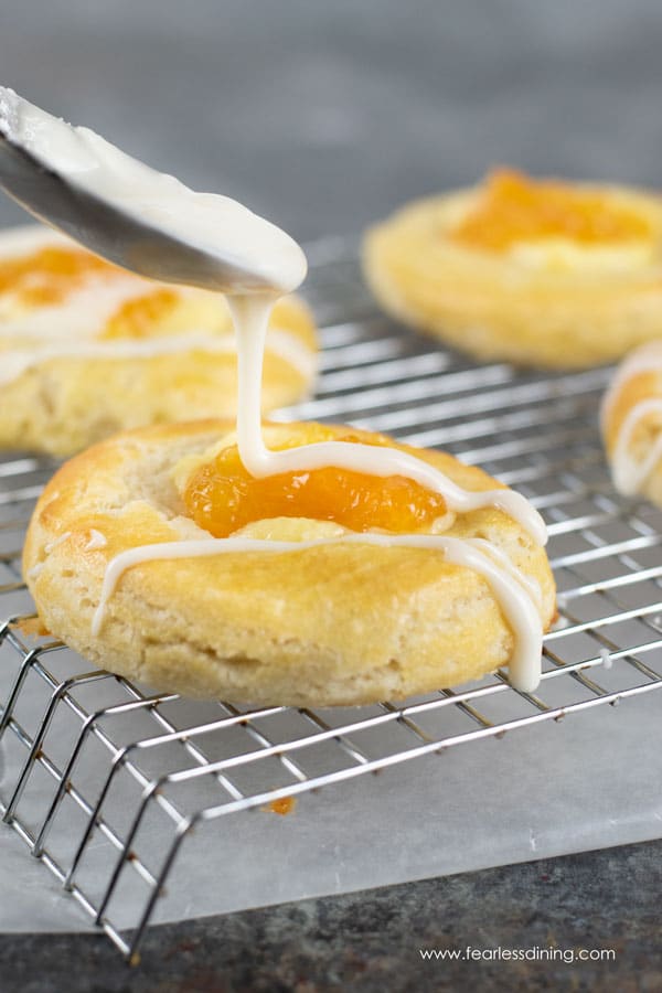 More gluten free cheese danish getting drizzled with icing.