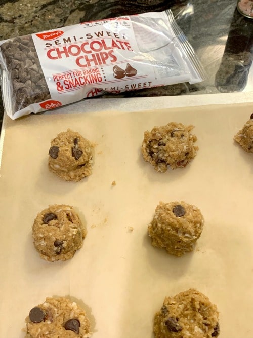 Paleo chocolate chip cookies on a cookie sheet ready to bake.