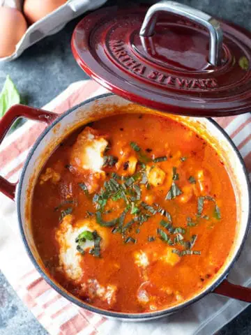 a Dutch oven filled with cooked shakshuka
