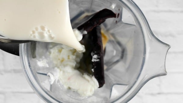 Pouring milk into the blender.