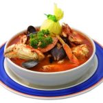 A photo of a big soup bowl filled with cioppino.