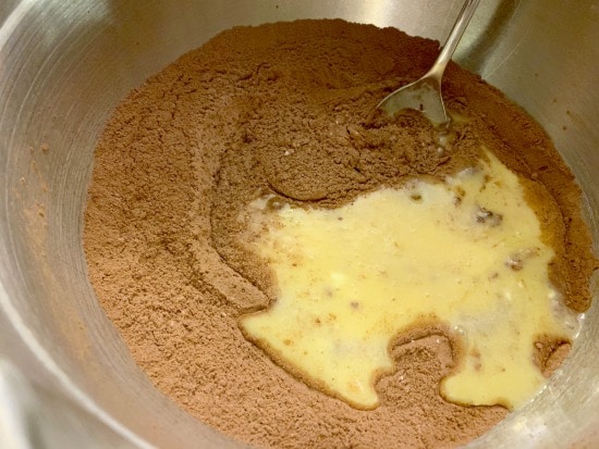 Wet and dry brownie ingredients being mixed.