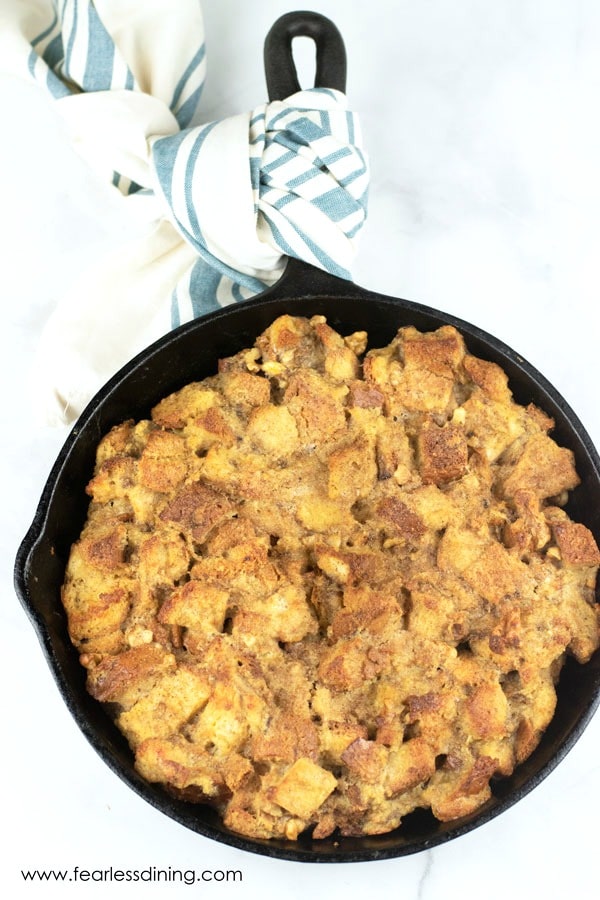 top view of a cast iron skillet filled with hot gluten free banana bread pudding