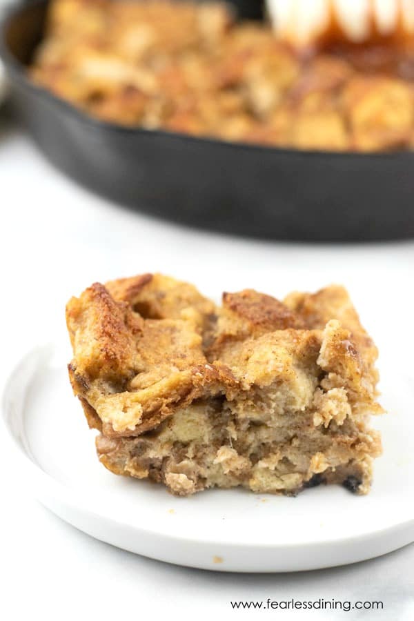 A slice of gluten free banana bread pudding on a plate.