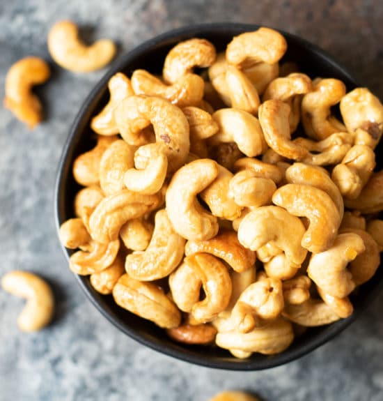 A closeup of a bowl of honey roasted cashews.