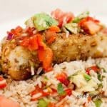 Pistachio Nut Crusted Halibut with Roasted Red Pepper Salsa on a plate with rice.