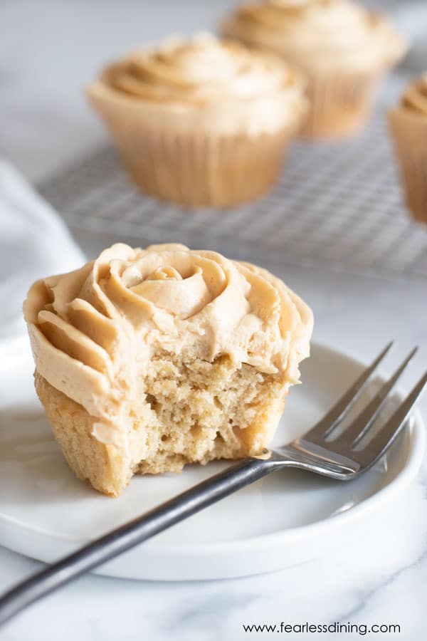 A fork next to a gluten free caramel cupcake.