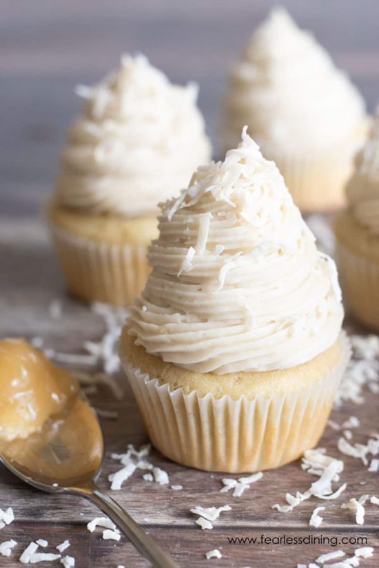 Three lemon curd filled gluten free lemon cupcakes.