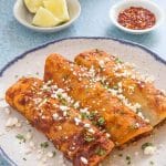 Beef enchiladas on a plate.