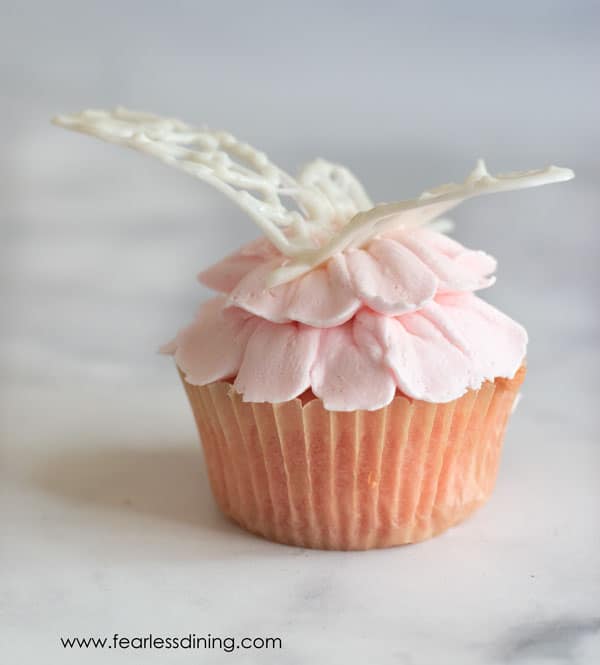 Another shot of the white chocolate dragonfly on a pink floral cupcake.