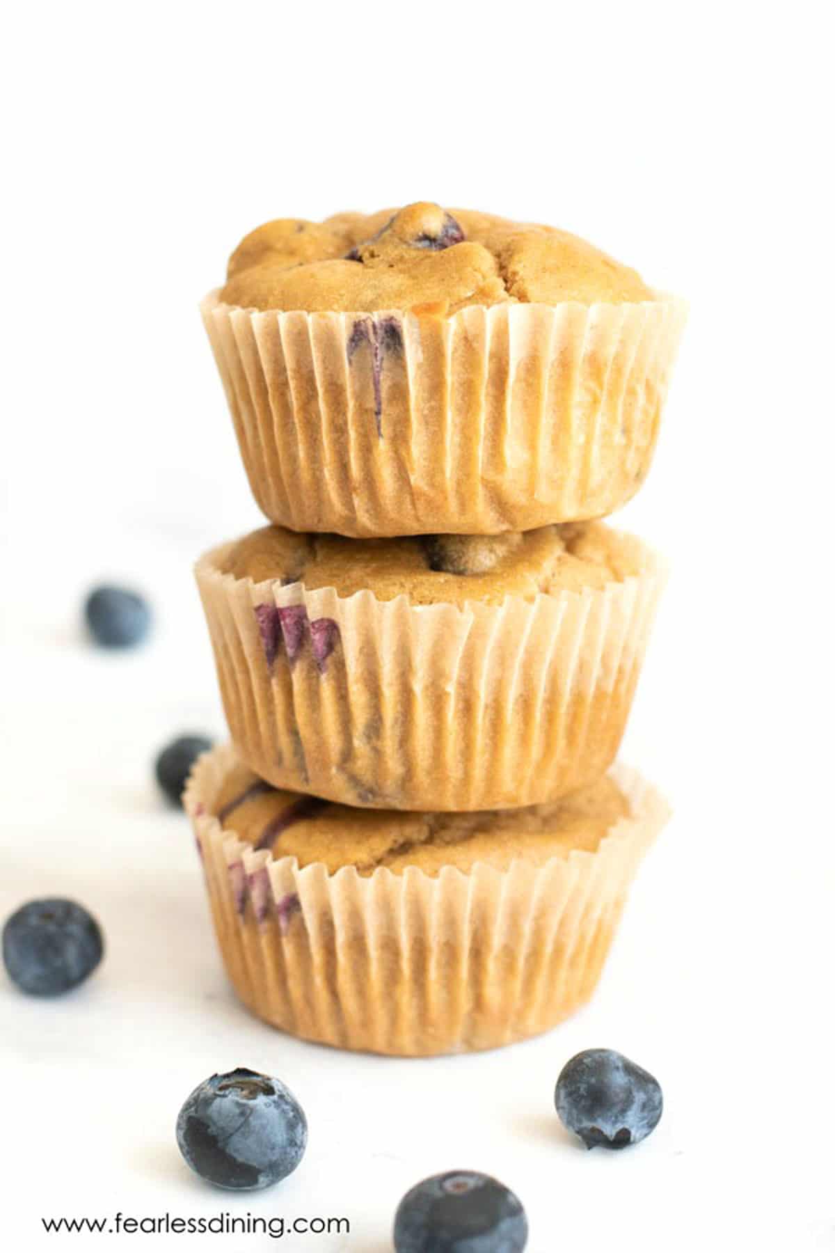 A stack of three blueberry muffins.