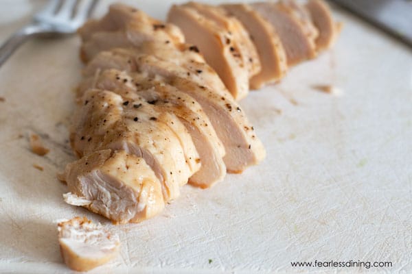 A sliced chicken breast on a cutting board.