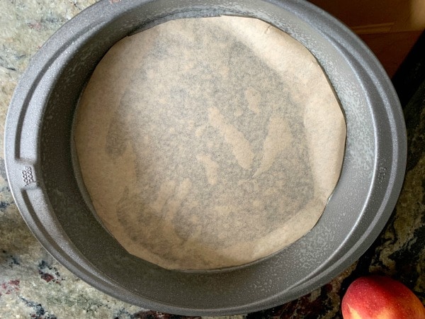 Parchment paper lining a cake pan.