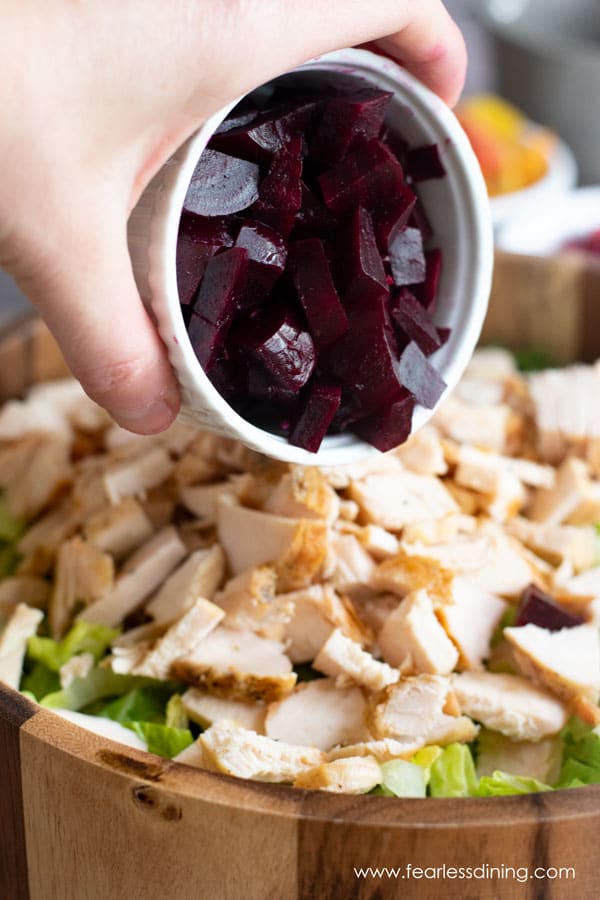 Adding diced beets to the salad.