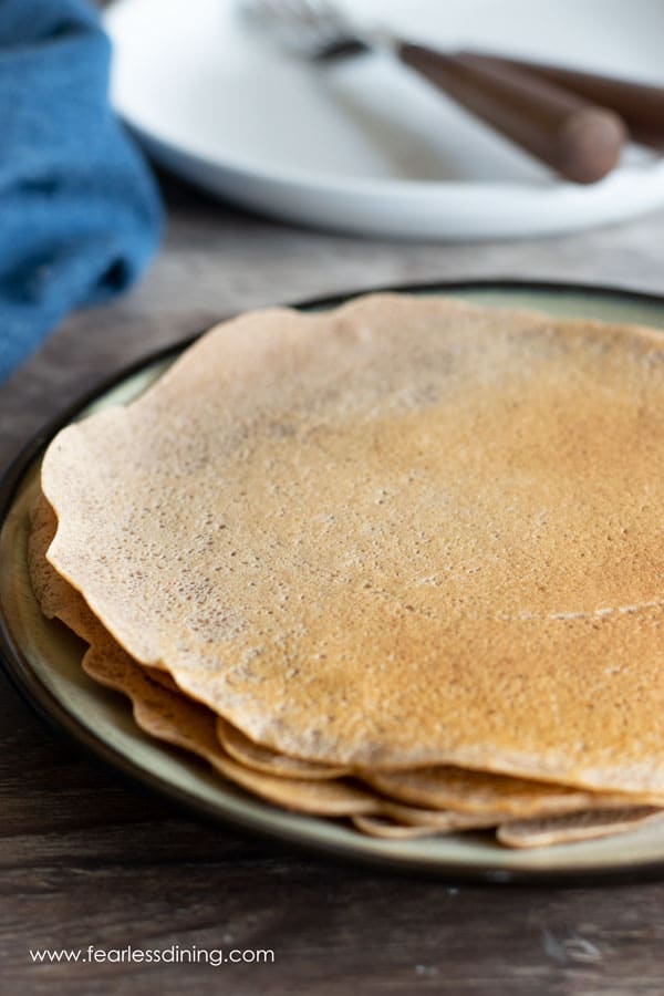 A stack of gluten free savory crepes on a plate.