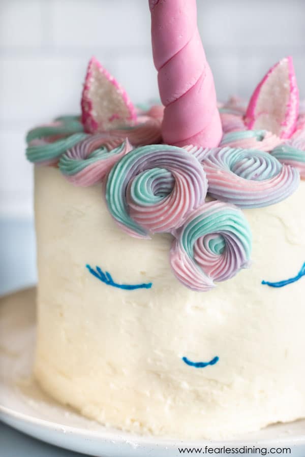 A close up of the gluten free unicorn cake's face.