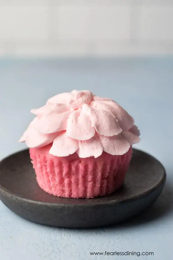 a pink lemonade cupcake on a plate