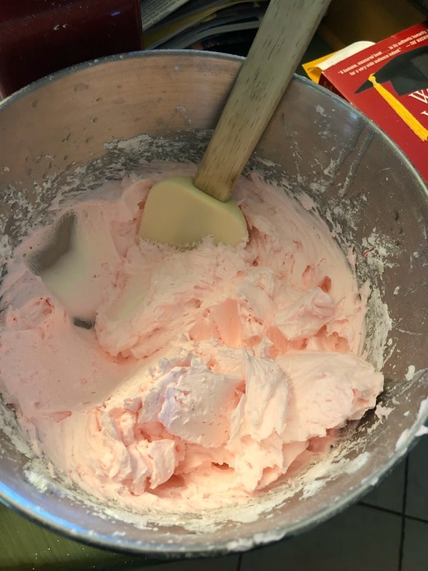 The pink lemonade frosting in a stand mixer bowl.