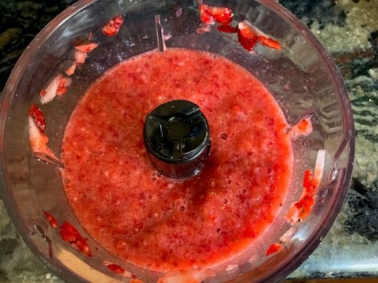 Pureed strawberries in a food processor.