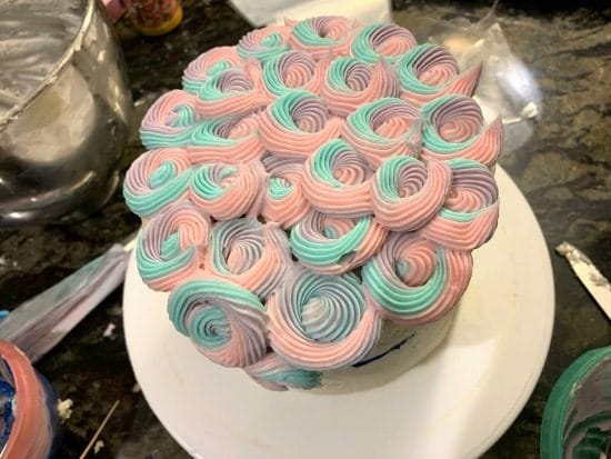 Rainbow frosting swirls to mimic a unicorn's mane.