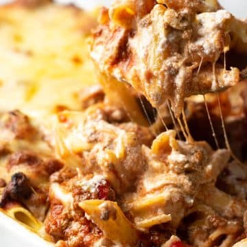 A big serving spoon full of ziti casserole.