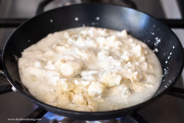 blue cheese, ricotta, and cream simmering on a stove