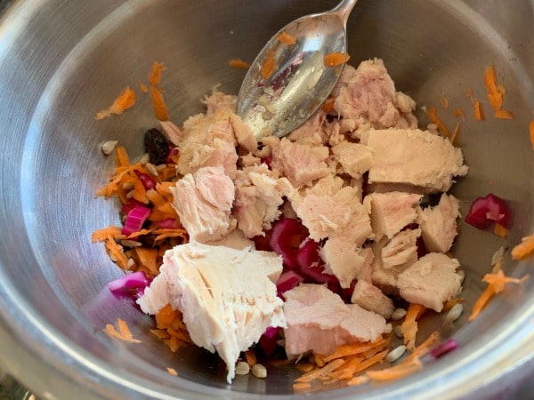 Tuna salad ingredients in a mixing bowl.